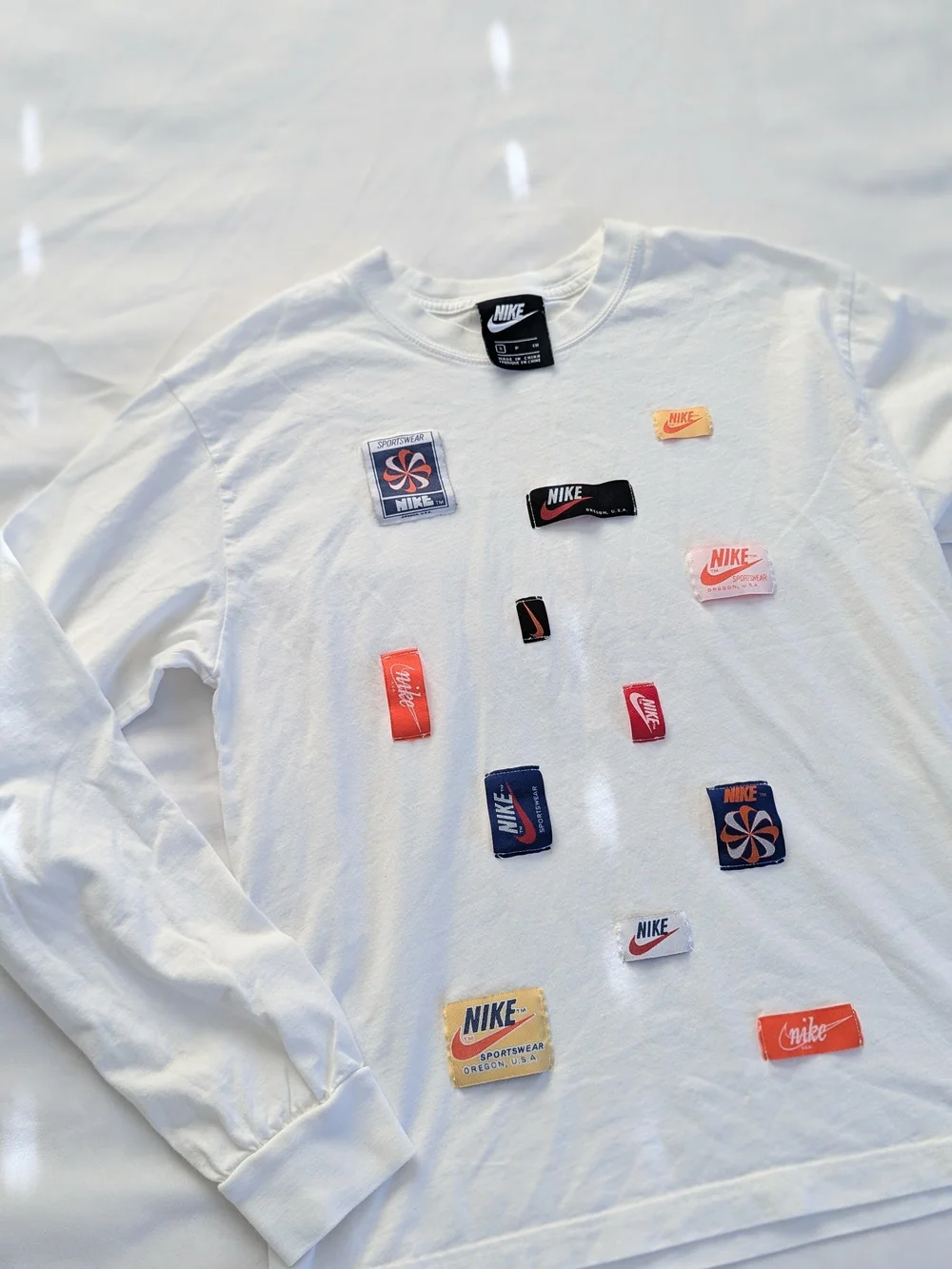 Nike White Long Sleeve Tee with Black and Red Logo Patches
